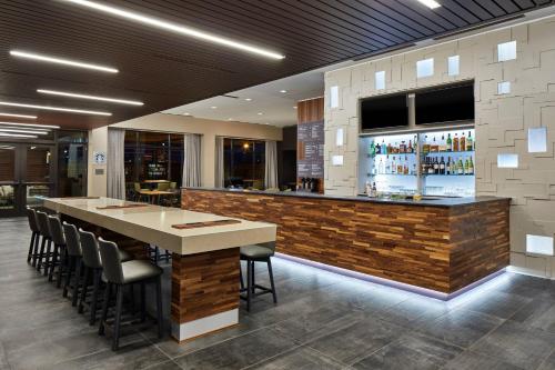 a bar in a restaurant with a counter and chairs at Courtyard Baltimore Downtown/McHenry Row in Baltimore