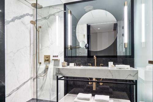 a bathroom with a sink and a shower at Academias Hotel, Autograph Collection in Athens