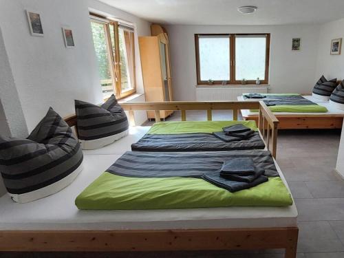 a room with two beds and a table and windows at Ferienwohnung, offenes Apartment in Bad Waldsee