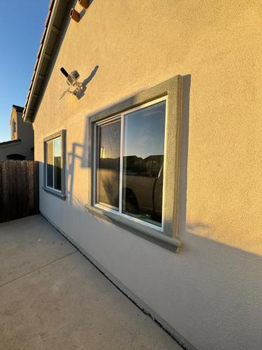 a window on the side of a building with a plane at Cozy Tiny House Near The Beach in Guadalupe