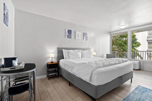 a bedroom with a bed and a desk with a computer at Hotolos Hollywood in Hollywood