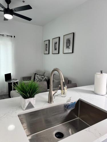 a kitchen sink in a kitchen with a couch at Cozy Tiny House Near The Beach in Guadalupe