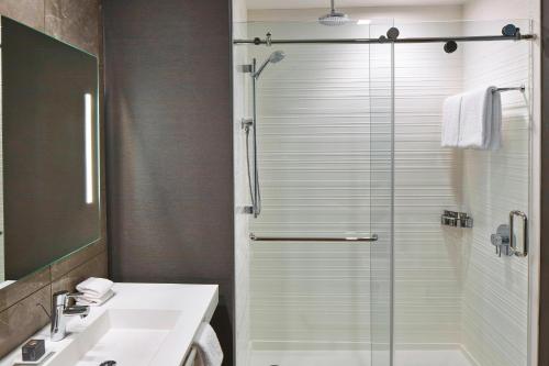 a bathroom with a sink and a glass shower at AC Hotel Columbus Dublin in Dublin