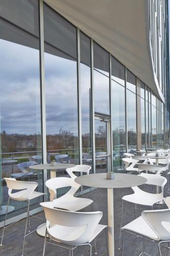 a row of tables and chairs in a building with windows at AC Hotel Columbus Dublin in Dublin