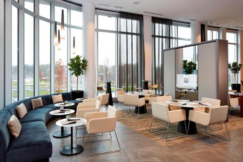 a lobby with a couch and tables and windows at AC Hotel Columbus Dublin in Dublin