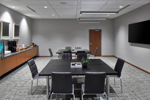 a conference room with tables and chairs and a flat screen tv at AC Hotel Columbus Dublin in Dublin