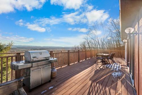 a patio with a grill and a table on a deck at Hidden Gem Best Views Unbeatable Seclusion etc in Albrightsville