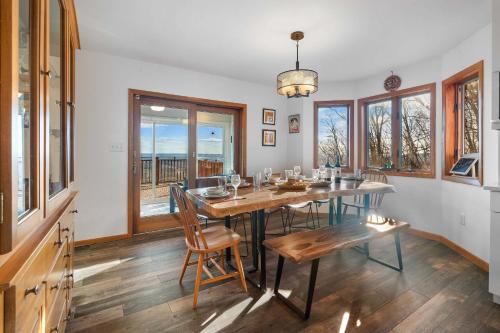 a dining room with a table and chairs and windows at Hidden Gem Best Views Unbeatable Seclusion etc in Albrightsville