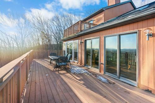 a deck with a table and chairs on a house at Hidden Gem Best Views Unbeatable Seclusion etc in Albrightsville