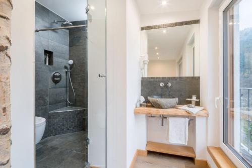 a bathroom with a sink and a shower at Regina's Gästehaus in Weisenbach