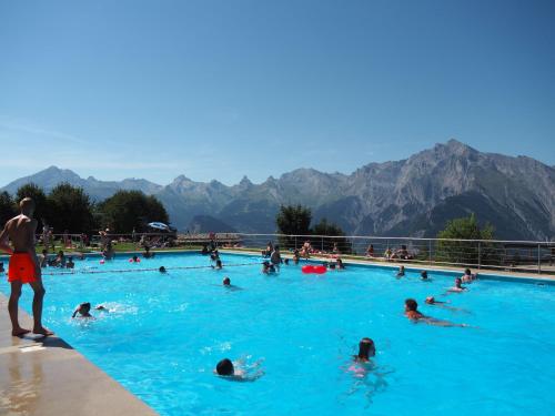 a group of people swimming in a swimming pool at Pracondu 1 202 - OUTDOOR & FUN charming apartment 8 pers in Nendaz