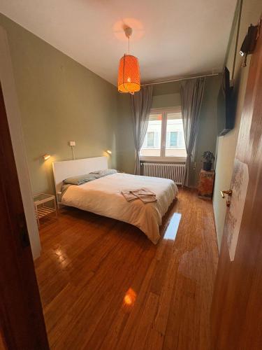 a bedroom with a bed and a large window at Terra Cielo alloggio di Porta Santi in Cesena