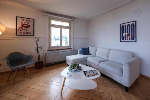 a living room with a couch and a table at Boutique Apartment Lakeview Luzern 2 in Luzern
