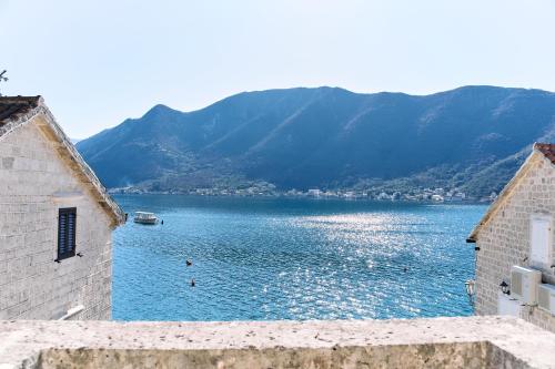 a view of a large body of water between two buildings at Waterfront Historical Villa Perast in Perast