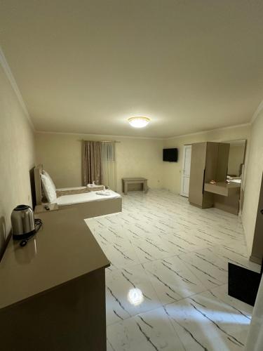 a room with a kitchen and a living room at Red Family Hotel in Vagharshapat
