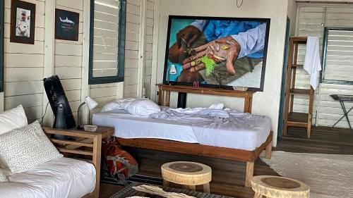 a room with a bed and a picture of a dog at Cabaña Cangrejo in Xcalak