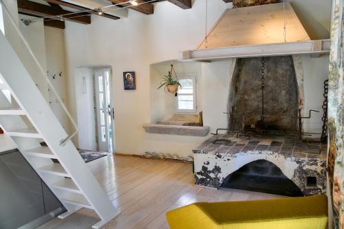 a living room with a fireplace and a staircase at Waterfront Historical Villa Perast in Perast