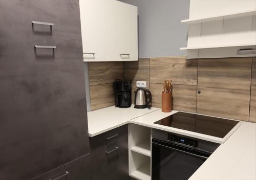 a kitchen with white cabinets and a stove top oven at Flensburg Süd in Flensburg