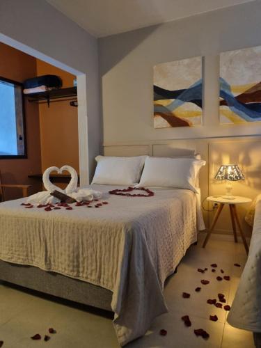 a bedroom with a bed with roses on it at Frieden Haus Hospedagem in Pomerode