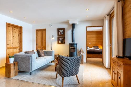 a living room with a couch and a tv at Chalet le 4 - Numéro 2 in Le Grand-Bornand