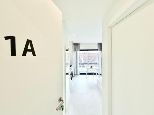 an open door to a white room with a table at SÉ - BRAGA Lounge Suites COLLECTION BY PERPETUAL RELAX in Braga