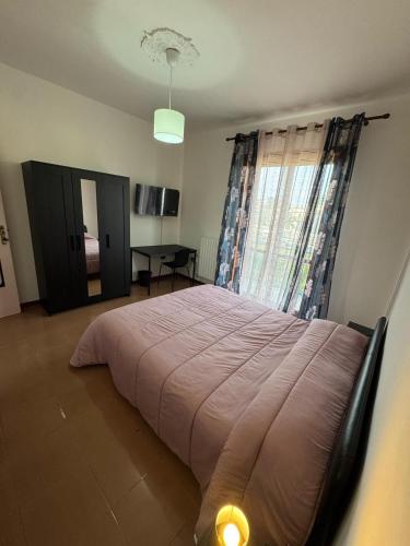 a bedroom with a large bed in a room at La Casa Di Gioia in Pagani