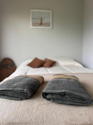 a bed with two pillows on top of it at Apart Containers, Acantilados, unidad in Mar del Plata