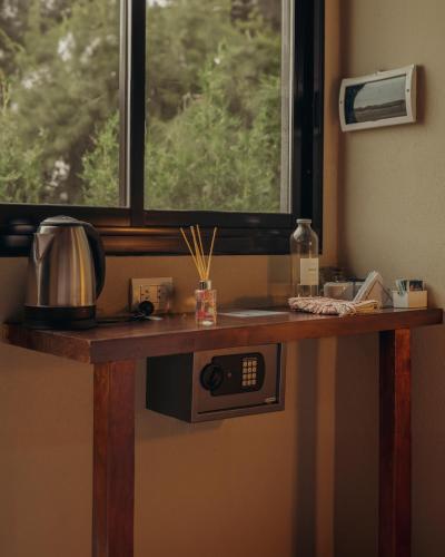 a kitchen counter with a window and a microwave at Olivos de Monte in San Miguel del Monte