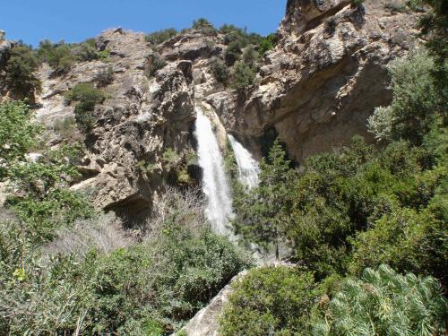 a waterfall on the side of a mountain at Jason Rooms & Studios in Keratokampos