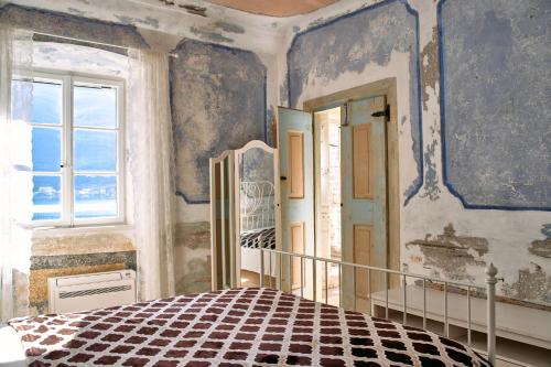a bedroom with a bed and a window at Waterfront Historical Villa Perast in Perast