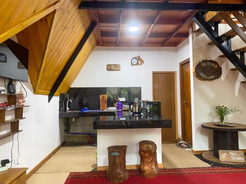 a living room with a counter and wooden ceilings at Barrow family cabana in Nuwara Eliya