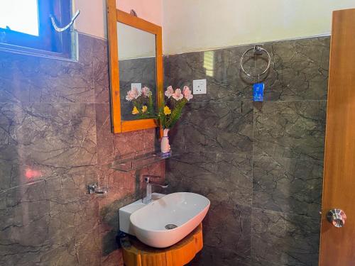 a bathroom with a sink and a toilet and a mirror at Barrow family cabana in Nuwara Eliya