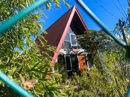 a house with a red roof at Barrow family cabana in Nuwara Eliya