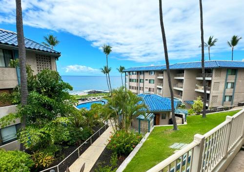 a view of the ocean from the balcony of a resort at Exceptional Kona Reef Condo - Full AC - Oceanfront - Walking Distance to Restaurants & Shops in Kailua-Kona