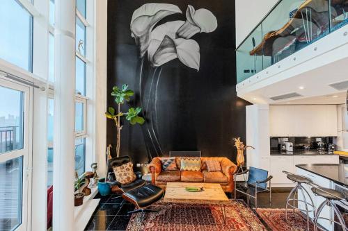 a living room with a couch and a table at London Canary Wharf Riverside Penthouse Apartment in London