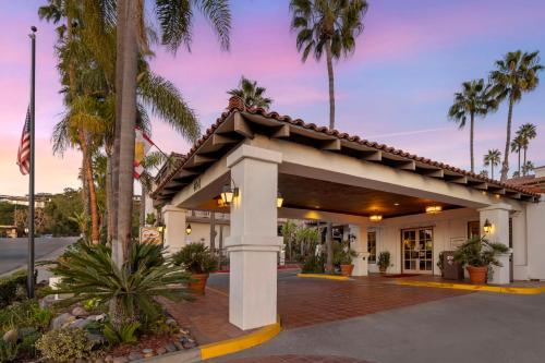 a hotel with palm trees and a building at Best Western Plus Hacienda Hotel Old Town in San Diego