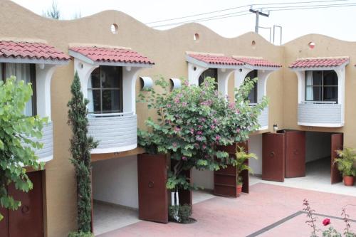 a row of houses with balconies and flowers at Hotel Real Ocotepec in Cuernavaca
