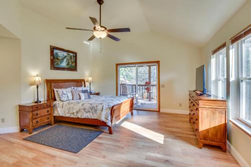 a bedroom with a bed and a ceiling fan at Blairsville Vacation Rental with Deck and Game Room! in Blairsville