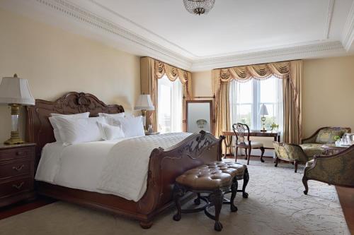 a bedroom with a large bed and a table and chairs at Market Pavilion Hotel in Charleston