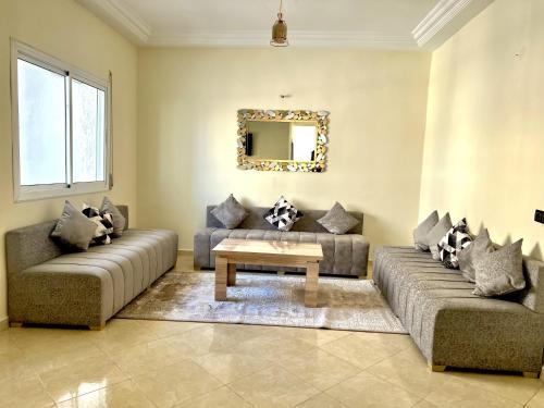 a living room with two couches and a table at Appart Hotel Fes - Joud Families & Travelers in Fès