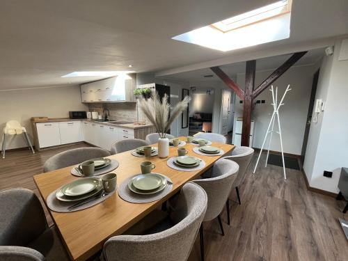a dining room with a wooden table and chairs at Apartament Prestige in Grudziądz