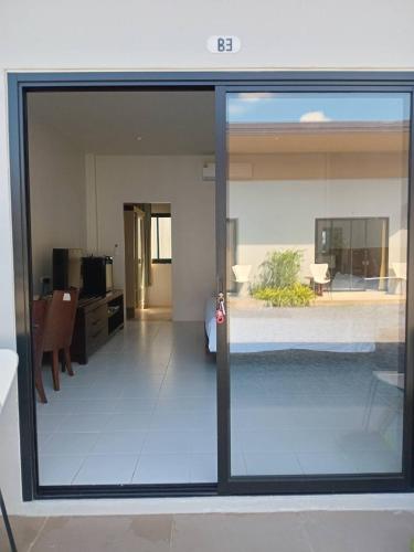 a view of a living room through a sliding glass door at PaKrongCheep Homestay in Ban Muang Mai