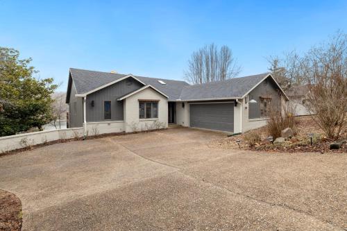 a house with a driveway in front of it at Dock Holiday - Hot Tub - Private Dock in Bella Vista
