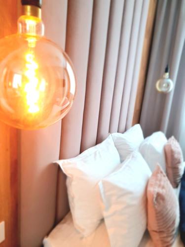 a lamp and pillows in a room with a window at Mianelly Center in Constanţa