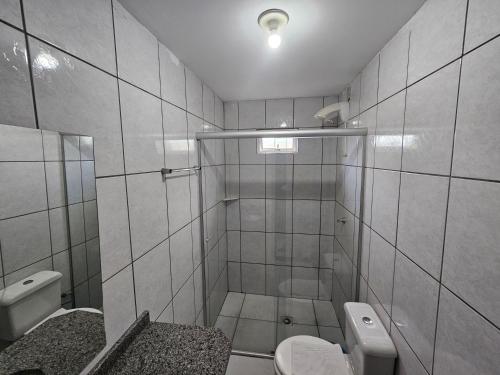 a bathroom with a shower and a toilet and a sink at Ok Inn Hotel Criciúma Centro in Criciúma