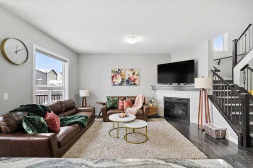 a living room with a couch and a fireplace at Large Family 4BR w Kid's Play Den! FREE Banff Pass in Calgary