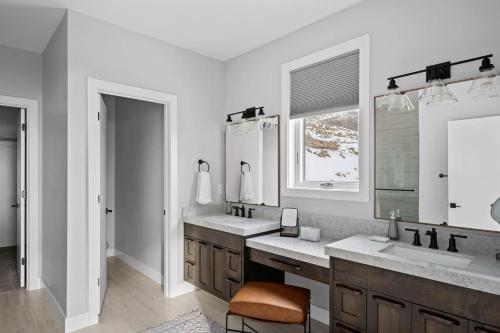 a white bathroom with two sinks and a mirror at Million-Dollar Views, Luxury Stay Near Park City in Keetley