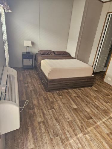 a bedroom with a bed and a wooden floor at El Dorado Suites in Crystal City