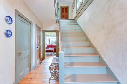 a staircase in a home with a blue stair case at Manchester Center Home with Green Mtn Views! in Manchester Center