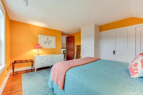 a bedroom with orange walls and a bed at Manchester Center Home with Green Mtn Views! in Manchester Center